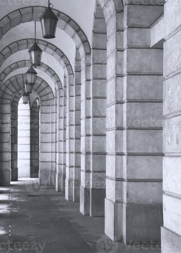 The arched stone colonnade with lanterns concept photo. Urban architectural photography. photo