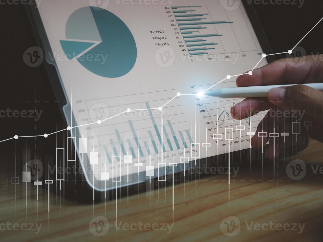 Man's hand pressing on tablet showing graph, income, return on investment. performance with digital technology photo