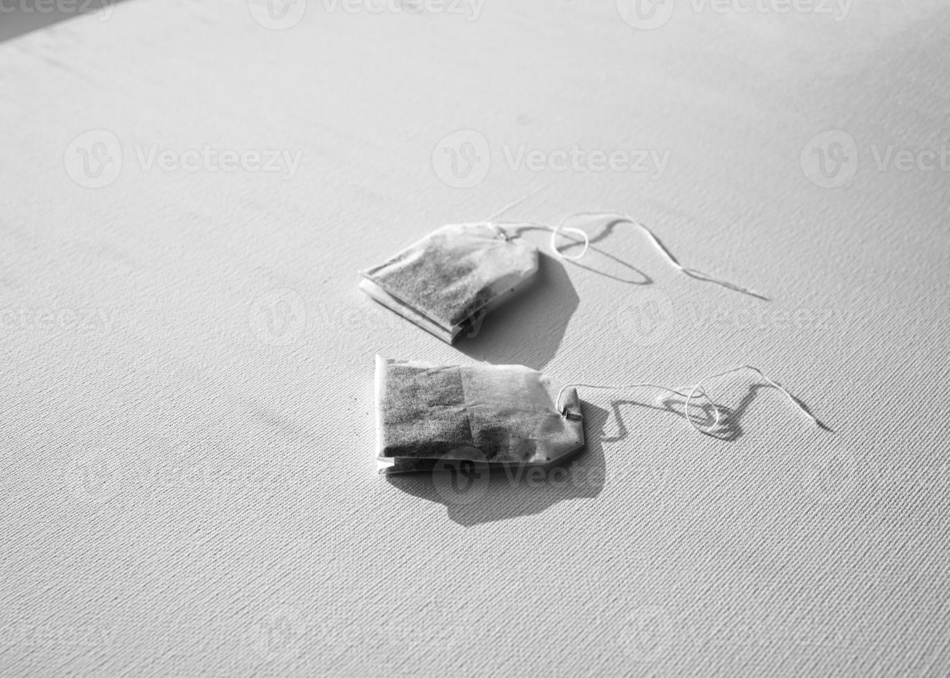 A tea bag with a label. Isolated on a white background photo