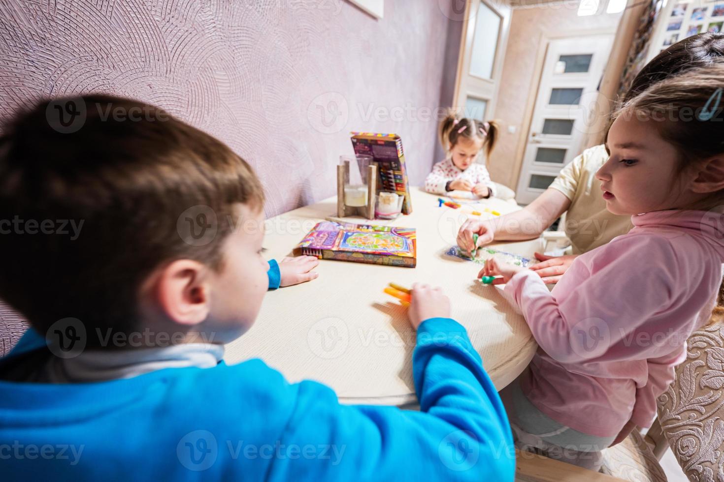 Mother and children decorating art with glitter decor. photo