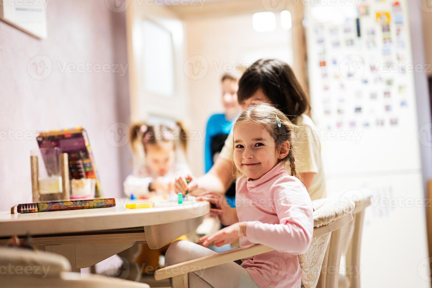 Mother and children decorating art with glitter decor. photo