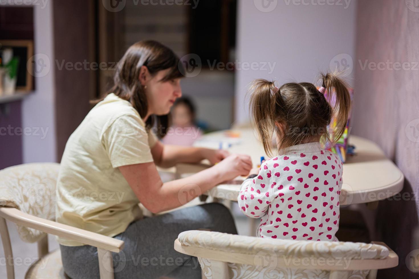 Mother and daughter decorating art with glitter decor. photo