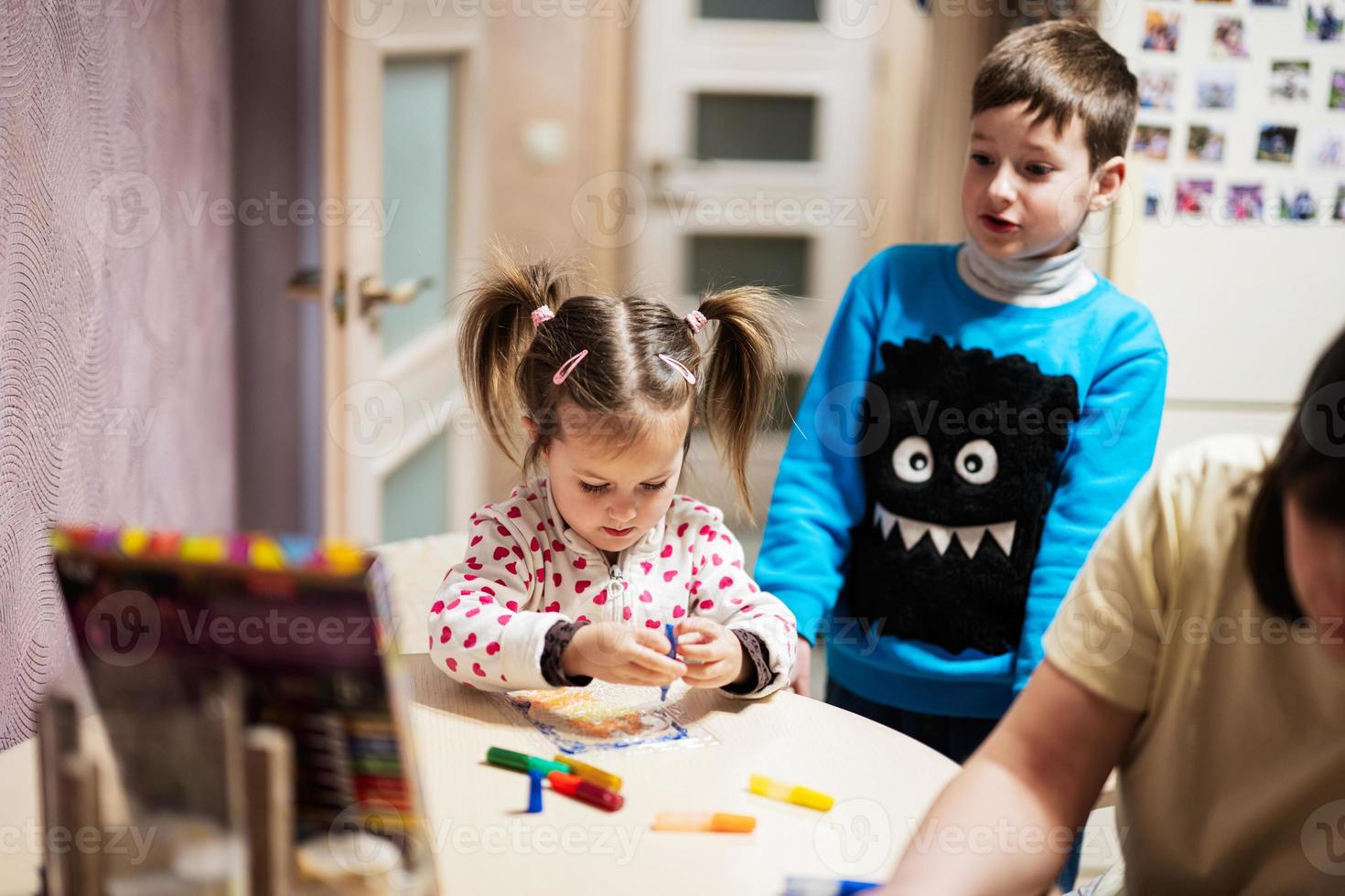 Mother and children decorating art with glitter decor. photo