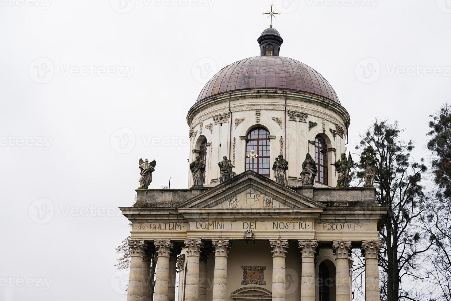 Baroque Roman Catholic church of St. Joseph mid 18th century. Latin on main facade - TO THE GLORY OF OUR LORD GOD, Pidhirtsi, Lviv Oblast, Ukraine. photo