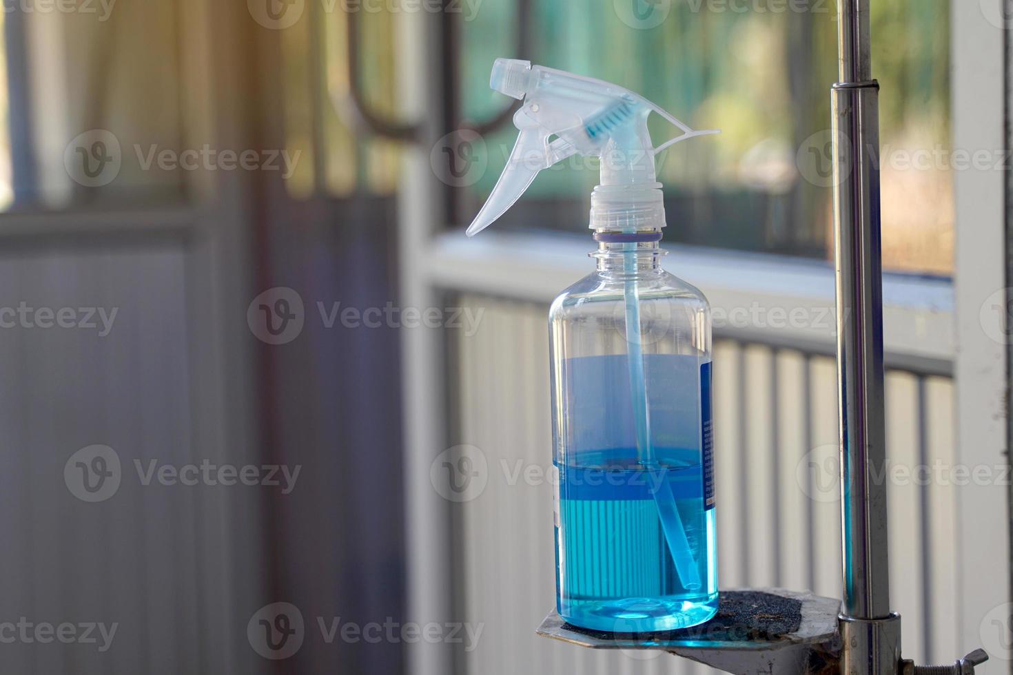 Alcohol spray bottle placed in front of the room. Use hand spray before entering the room. To prevent the spread of the corona virus COVID-19.soft and selective focus. photo