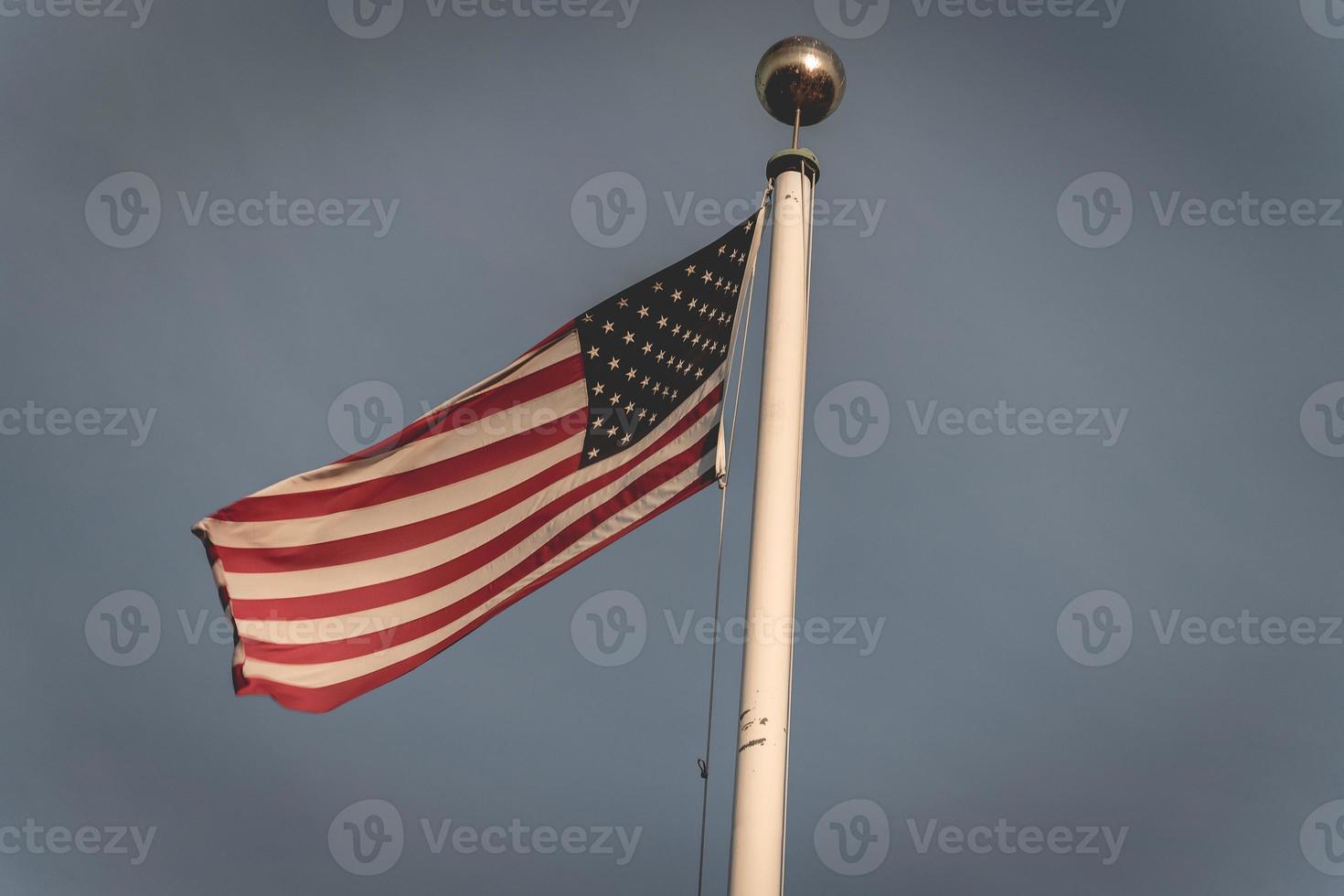 American flag waving in the wind, at the American cemetery at Magraten in The Netherlands. photo