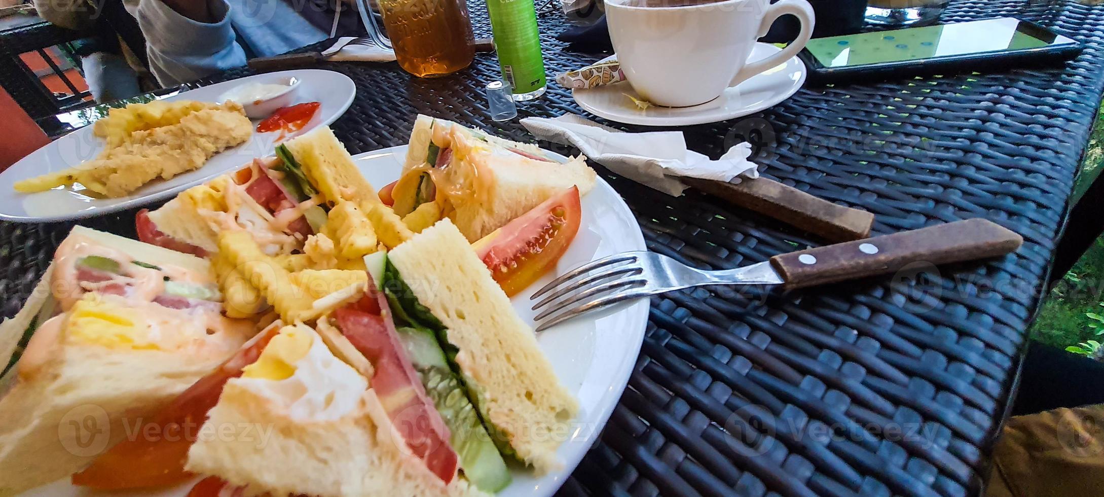 Western mainstay breakfast menu, meat sandwiches with vegetables combined with french fries photo