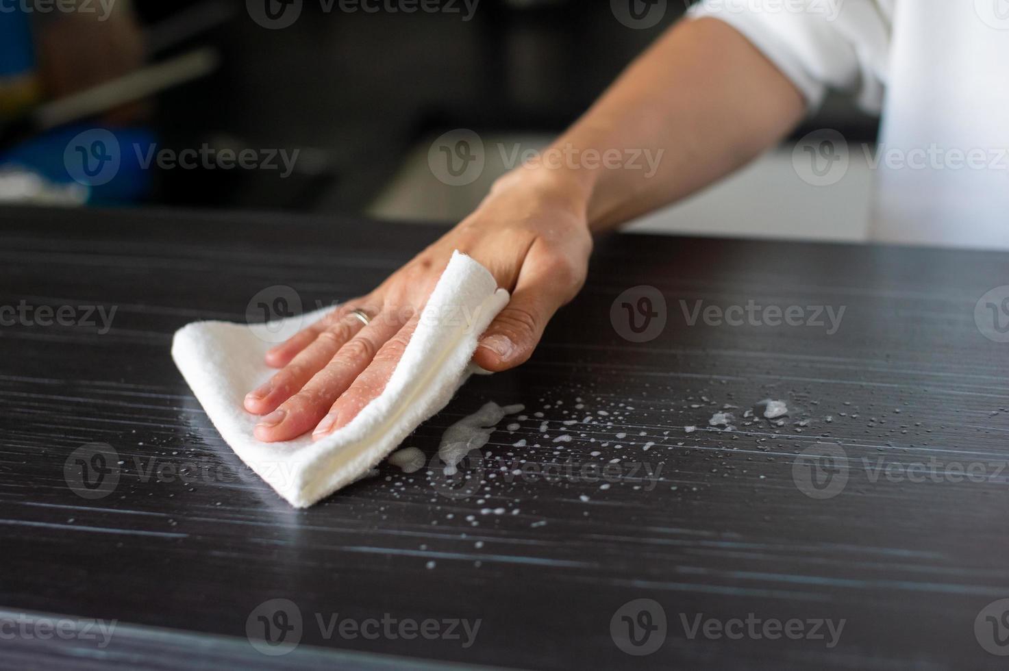 The girl does a wet cleaning of the living room and kitchen photo