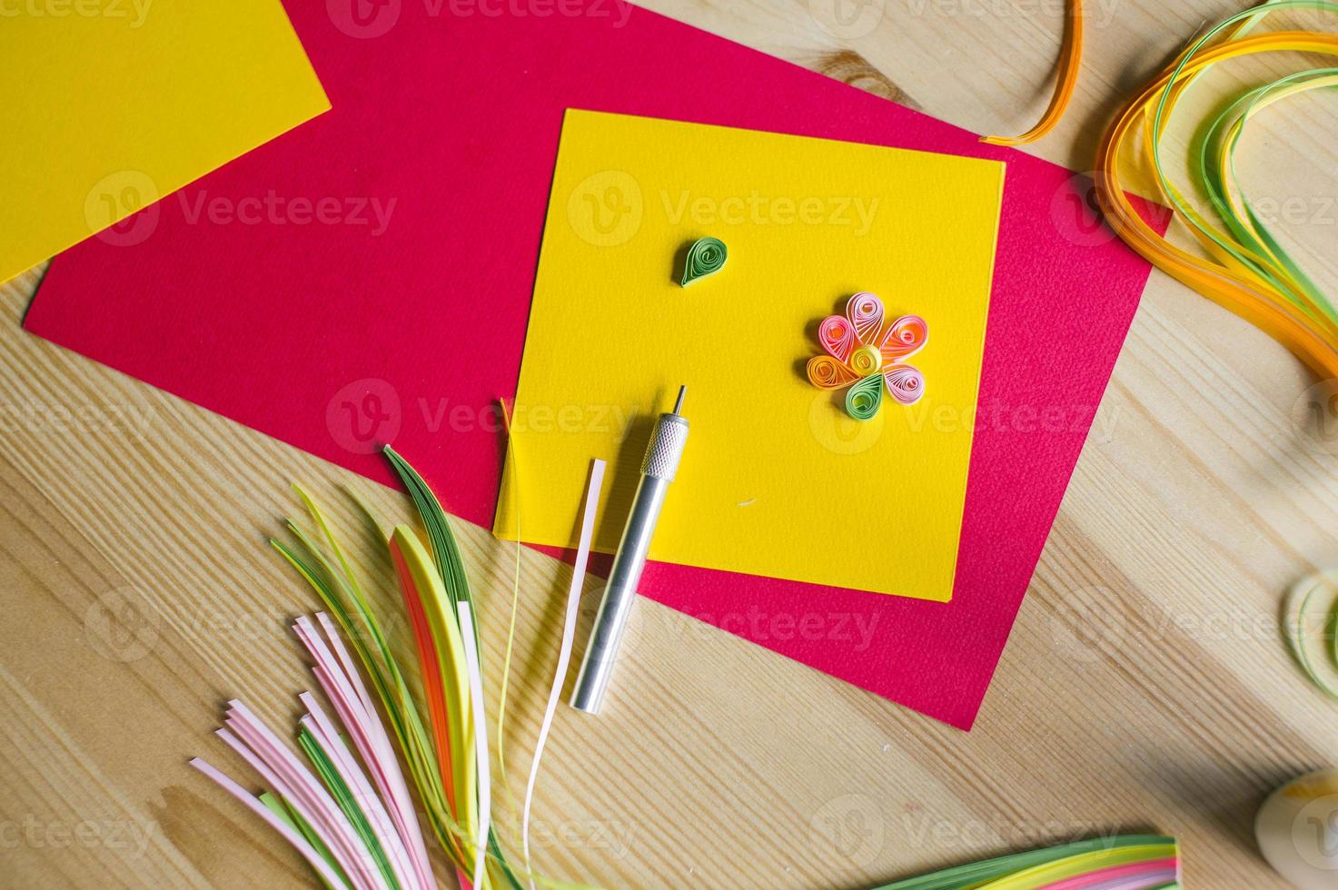 Making postcards from long and narrow strips of paper twisted into spirals, quilling photo