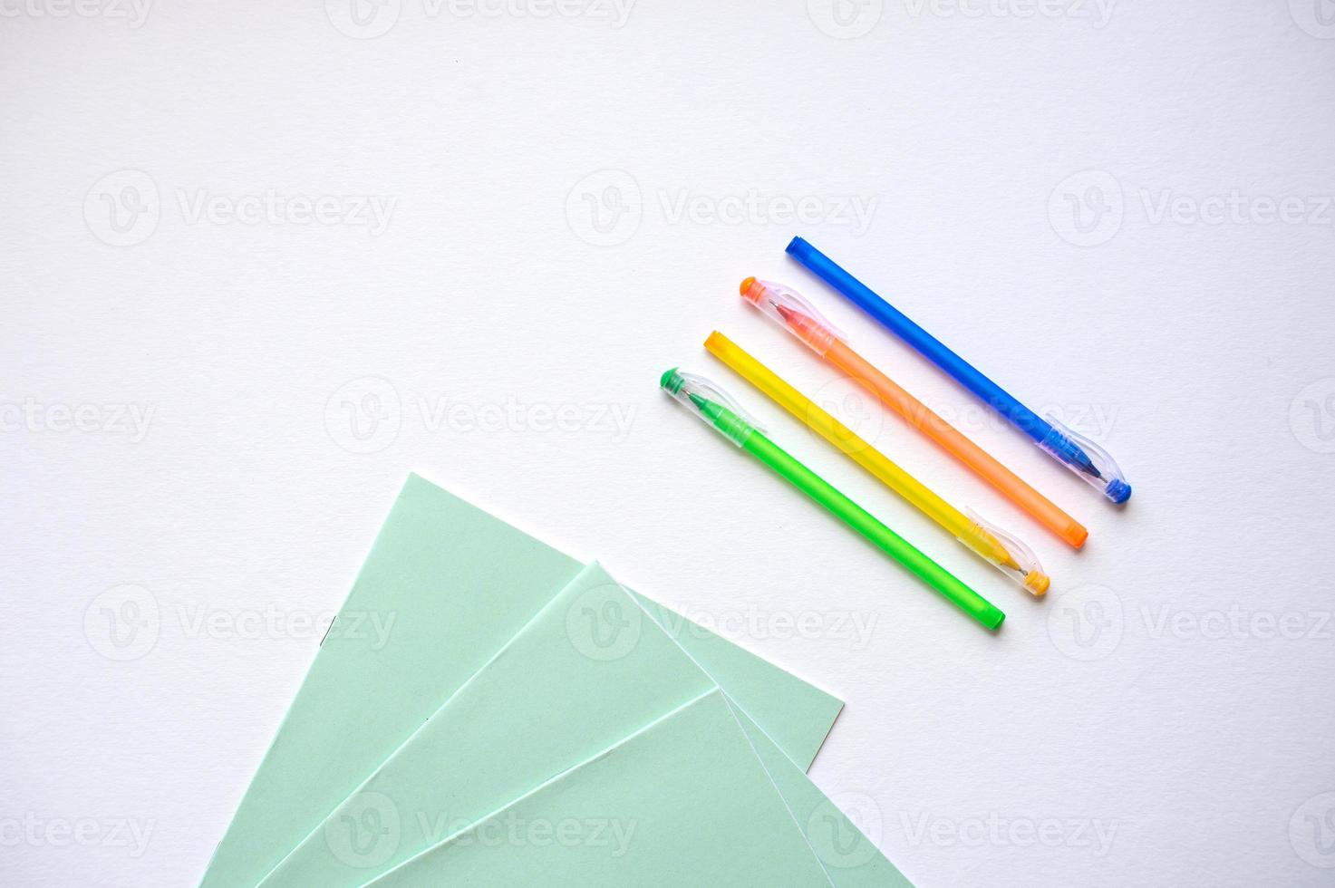 A set of stationery on a white background, pens of different colors photo