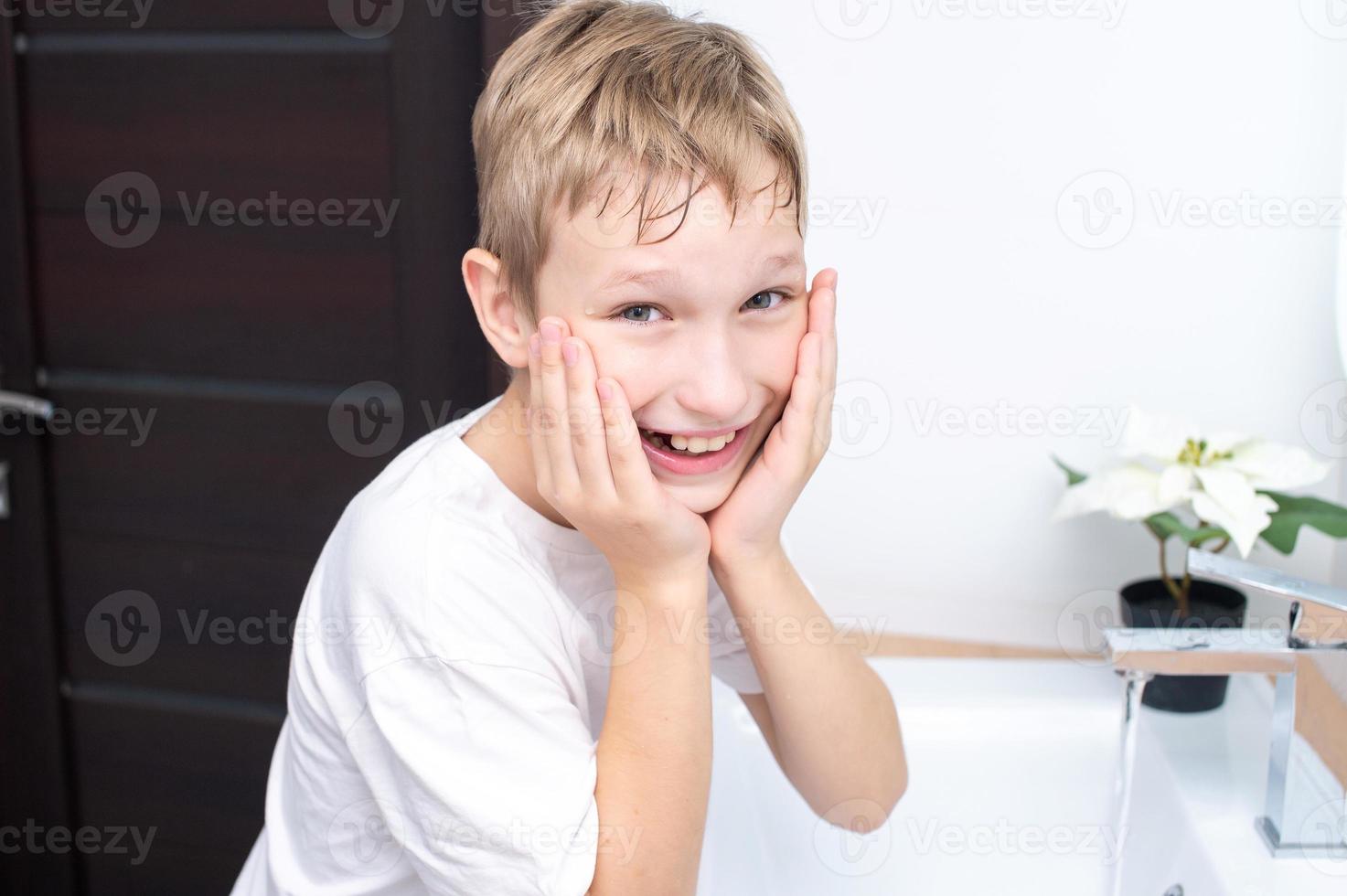 Cute boy washes and laughs photo