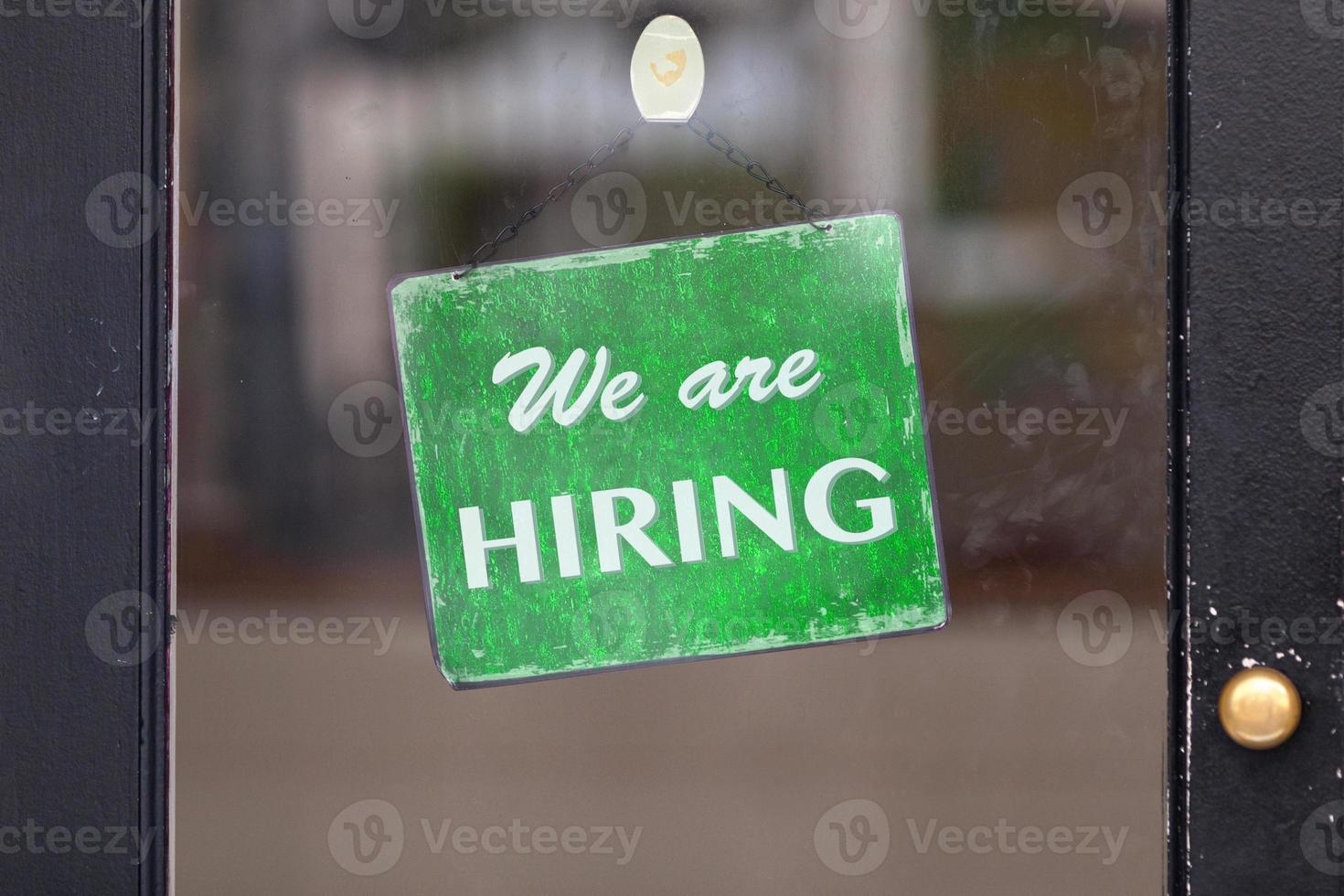 We are hiring sign in a window photo