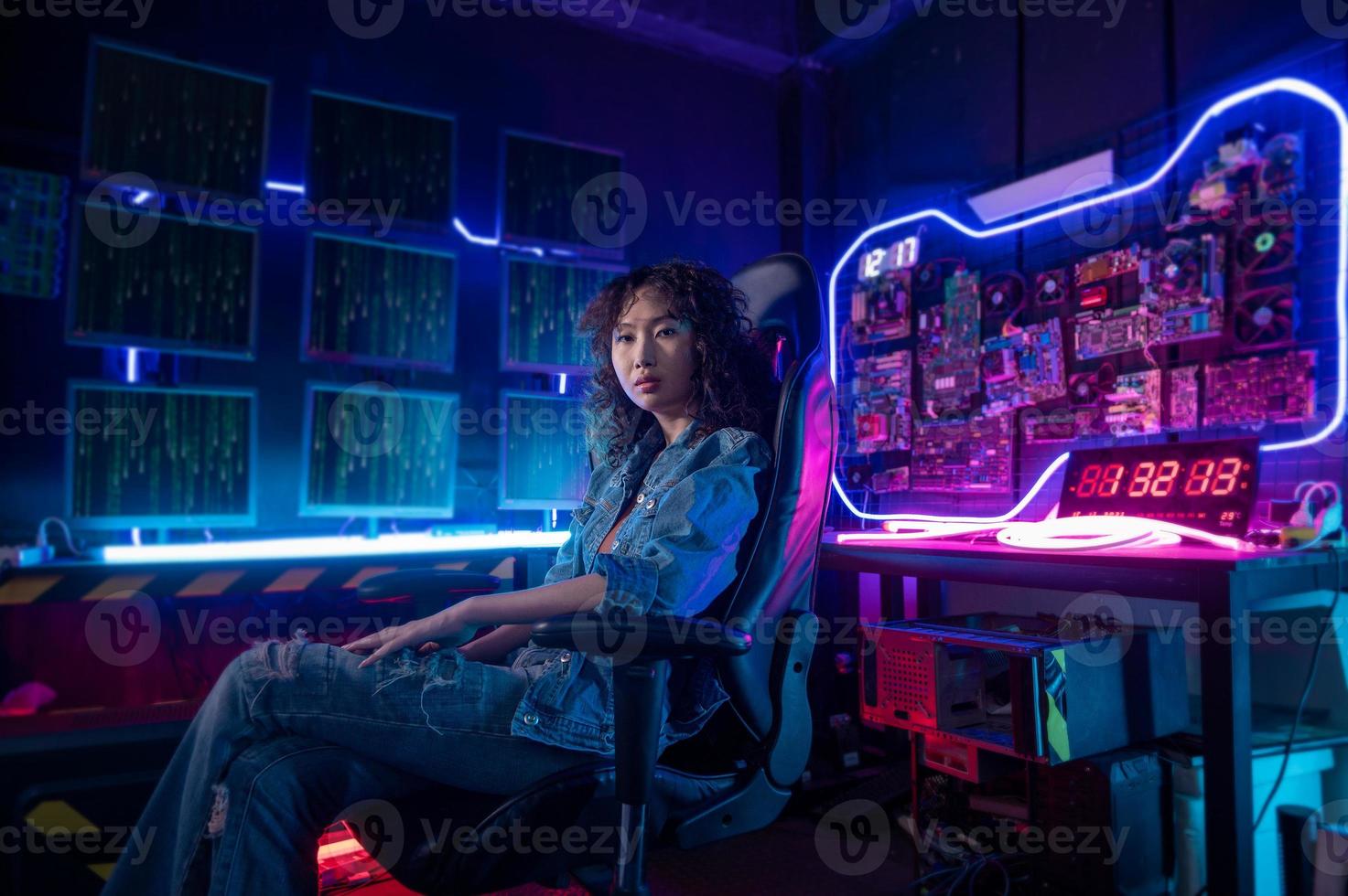 an asian woman programmer is working in her computer room , futuristic technology concept photo