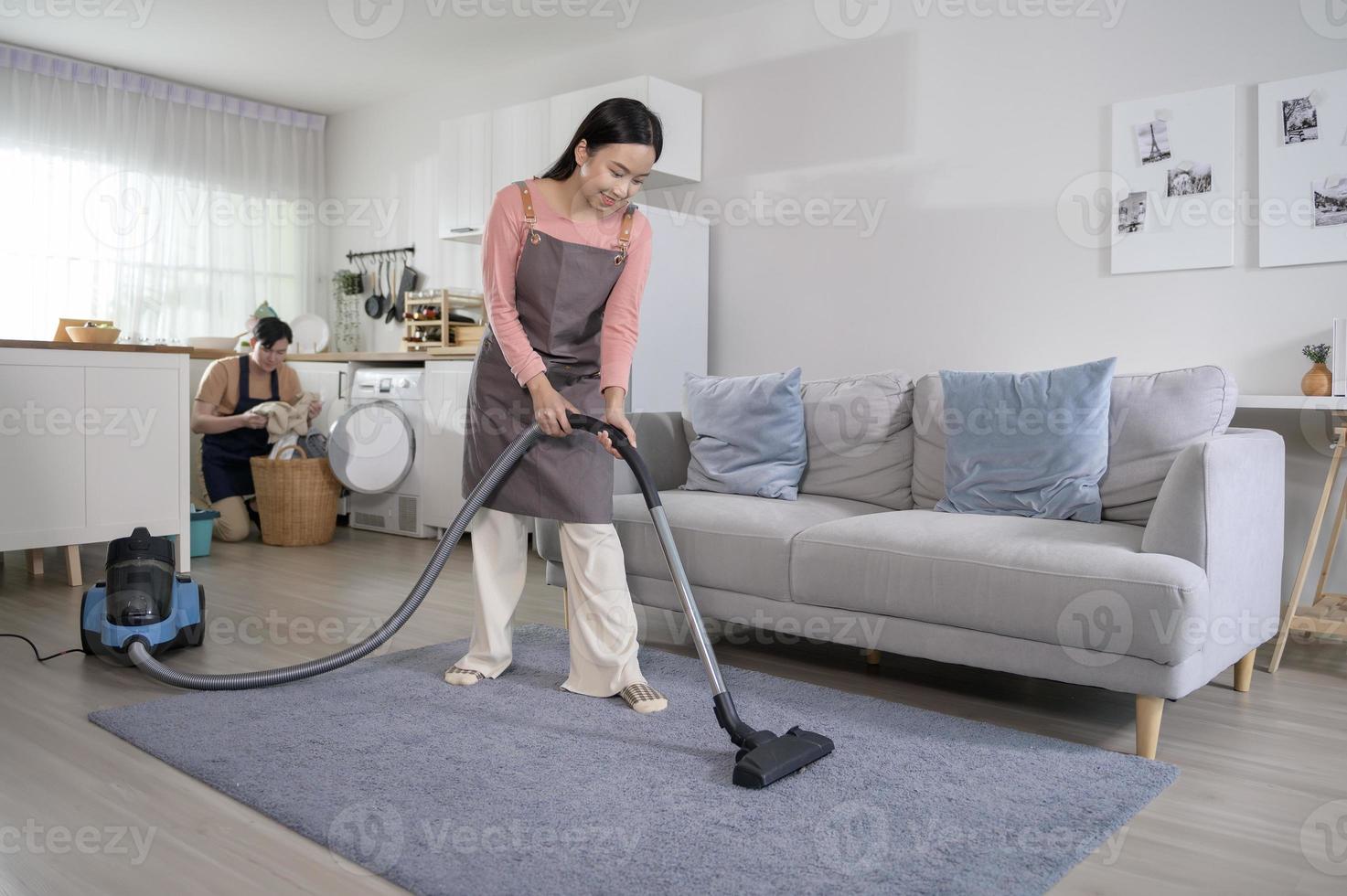 Happy young Asian couple cleaning home together, healthy lifestyle concept photo