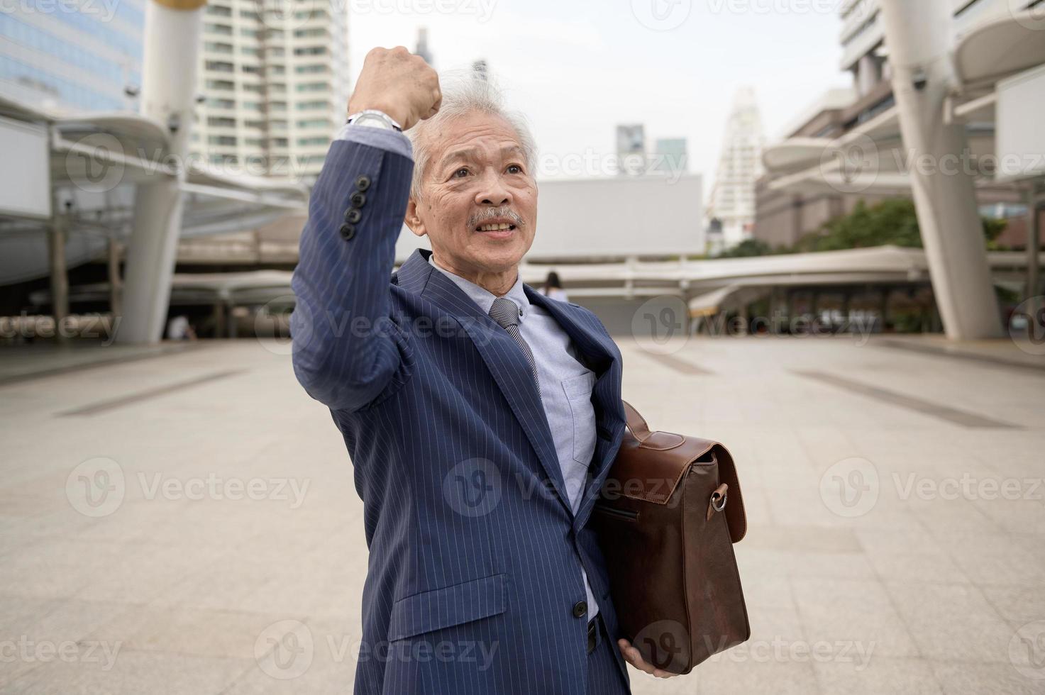 Happy senior  businessman celebrating successful of project in modern city photo