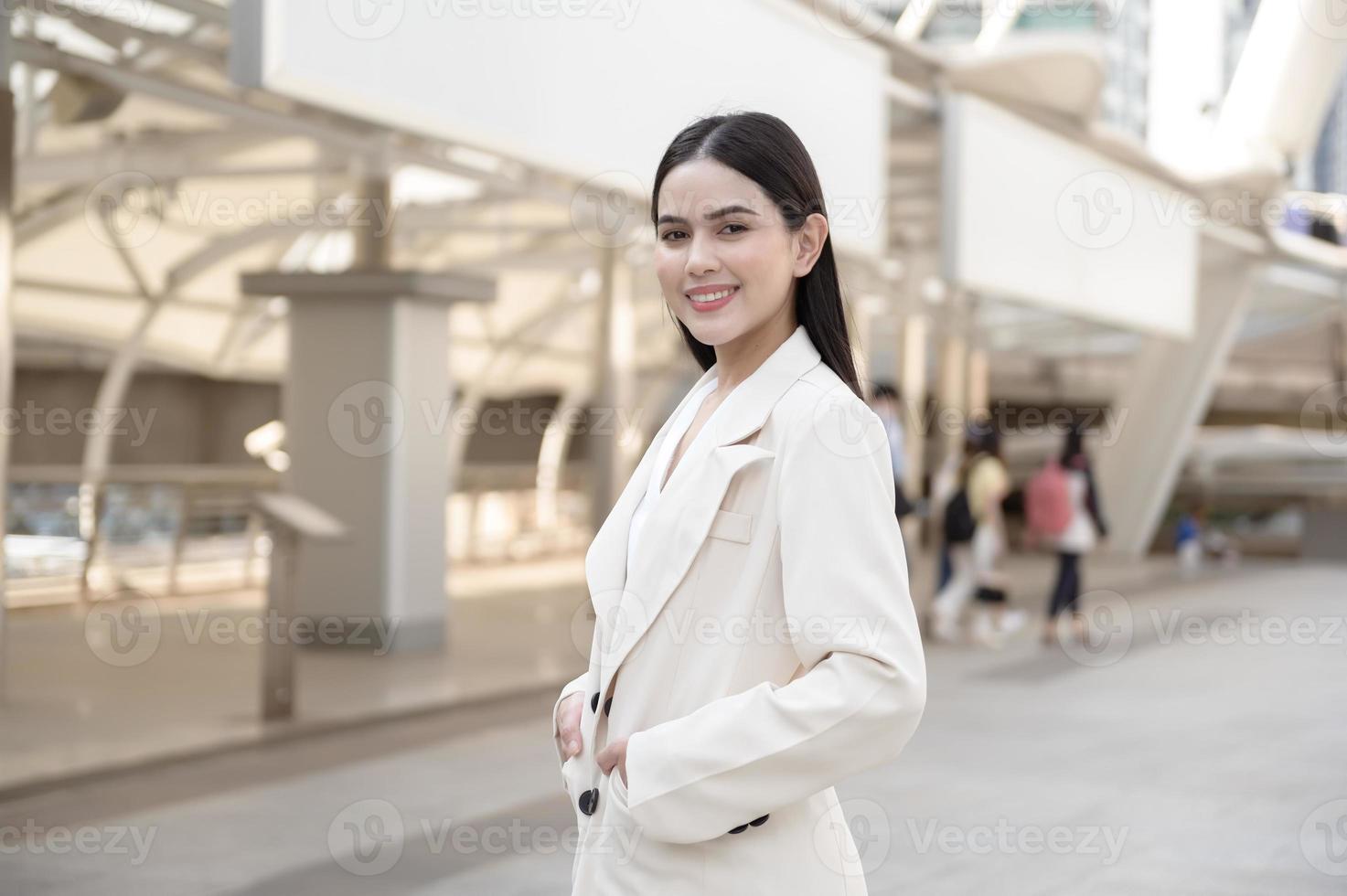 Portrait of young beautiful businesswoman in modern city photo