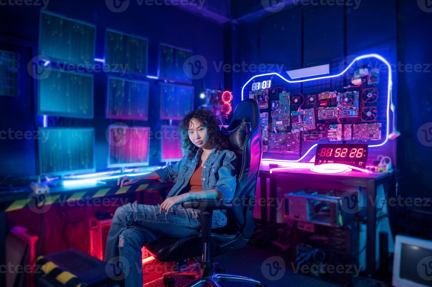 an asian woman programmer is working in her computer room , futuristic technology concept photo