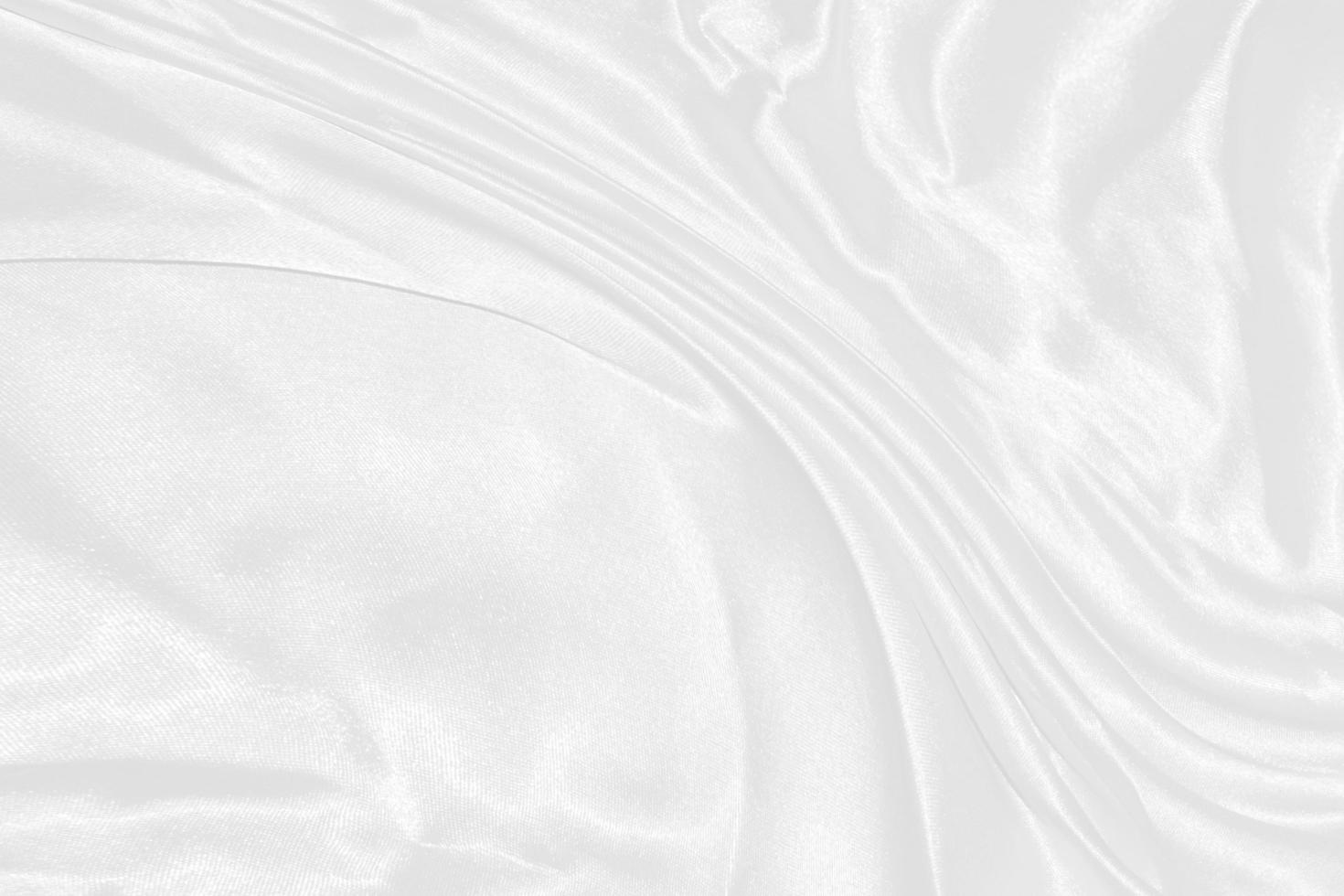 white silk textured cloth background,Closeup of rippled satin fabric with soft waves. photo