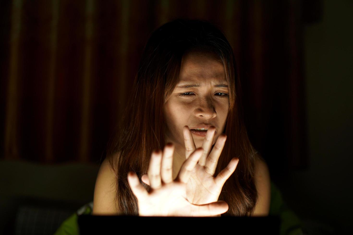 Asian women suffer from eyestrain from looking at computers in low light. watch movies online photo