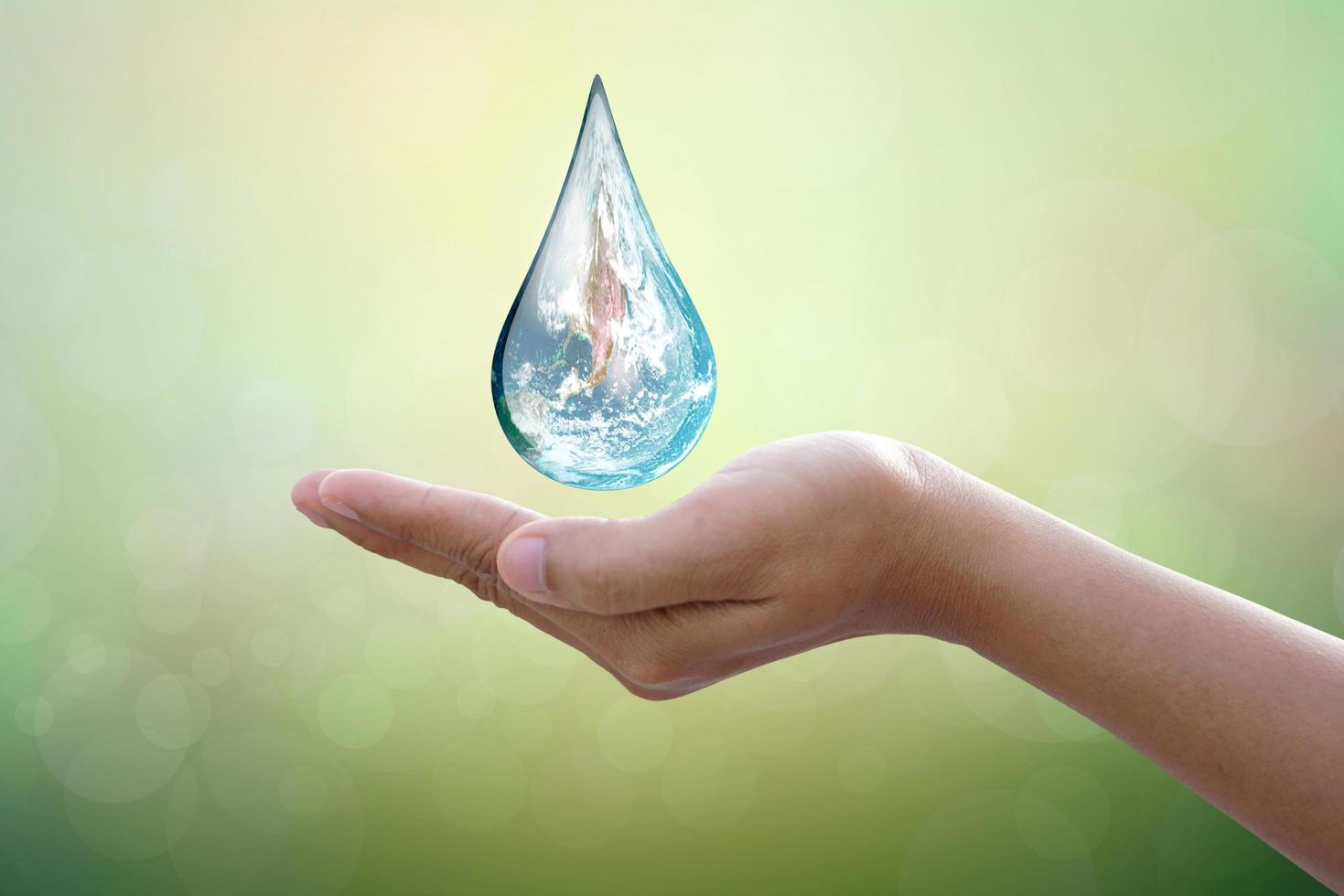 concept of saving the world water droplets on human hands photo