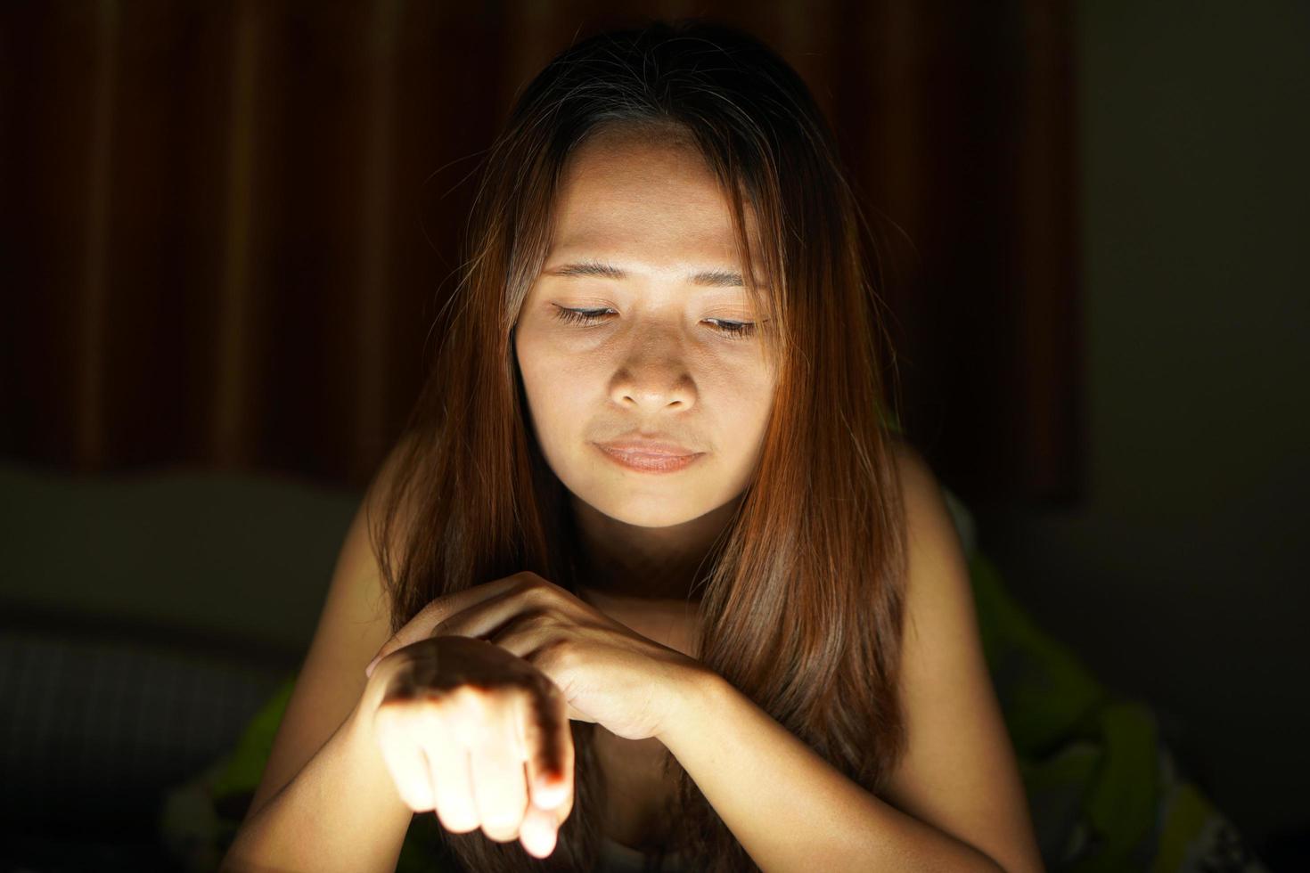 Asian women suffer from eyestrain from looking at computers in low light. watch movies online photo