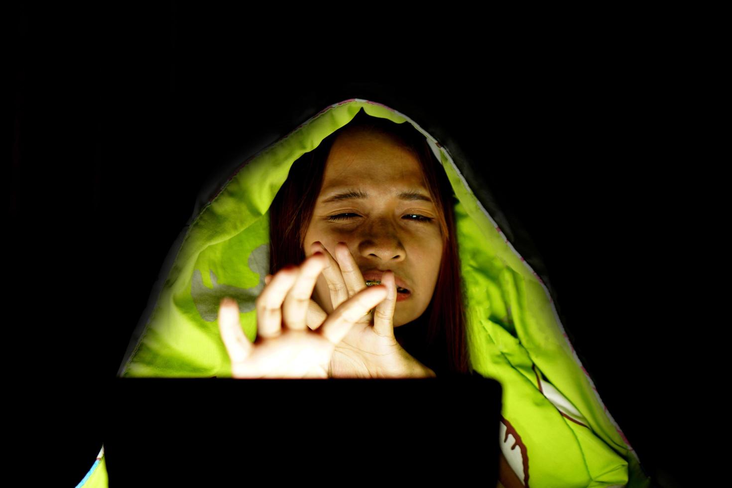 Asian women suffer from eyestrain from looking at computers in low light. watch movies online photo