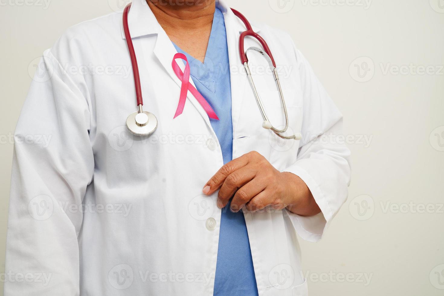 Asian woman doctor with pink ribbon, World Breast Cancer Day at October. photo