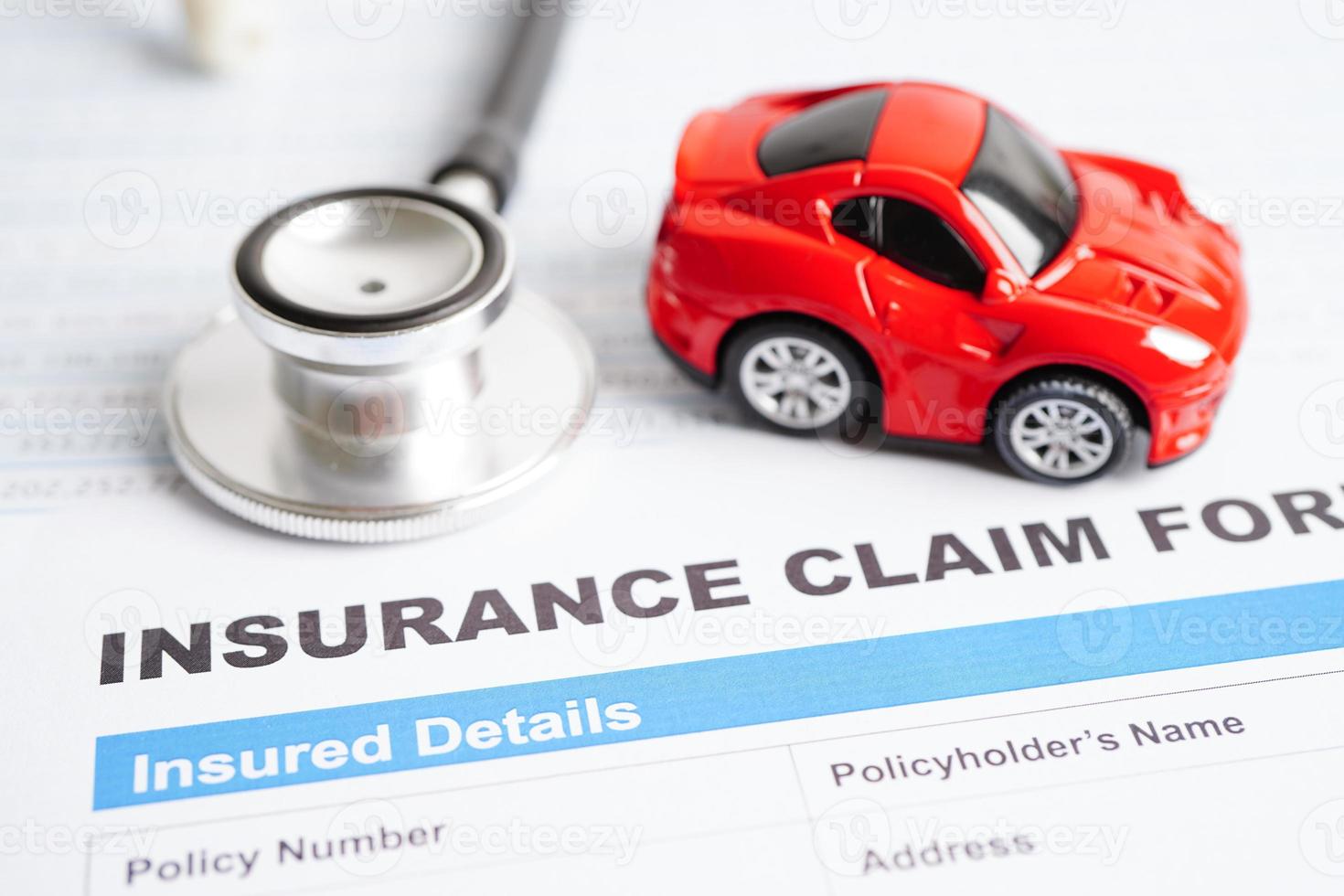 Stethoscope on Insurance claim accident car form, Car loan, insurance and leasing time concepts. photo