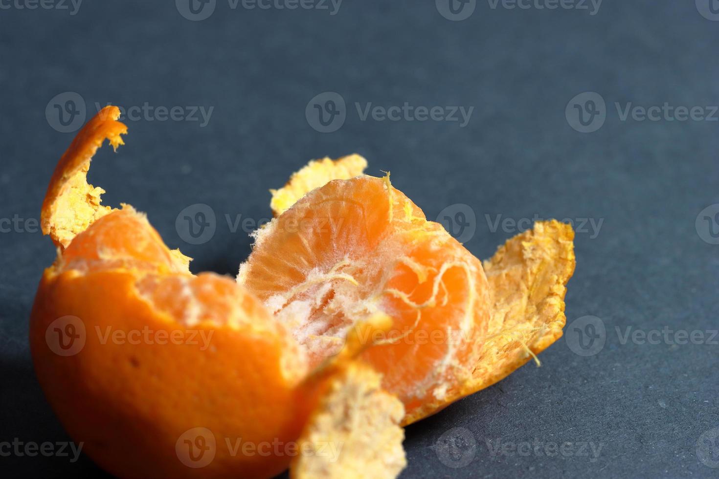 Orange peeled skin on a texture background photo