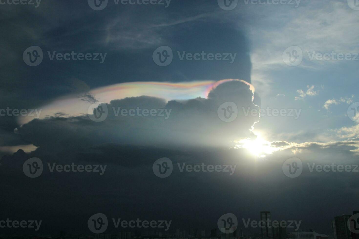 dark blue cloud with white light sky and sun ray with rainbow color reflection background photo