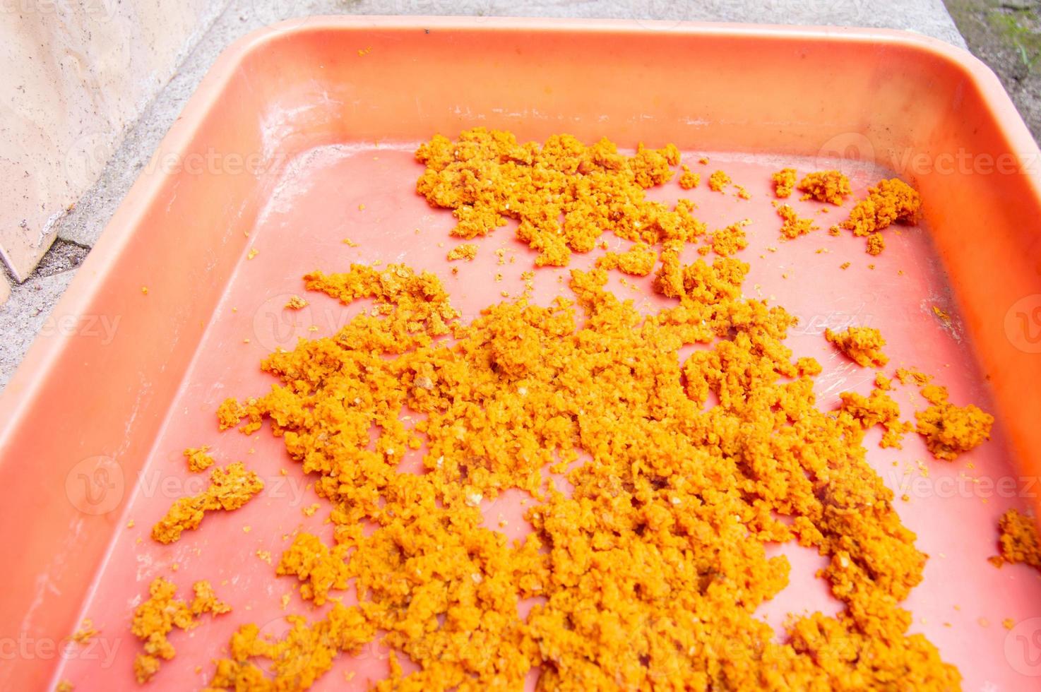 ground turmeric that is dried in the sun on a tray photo