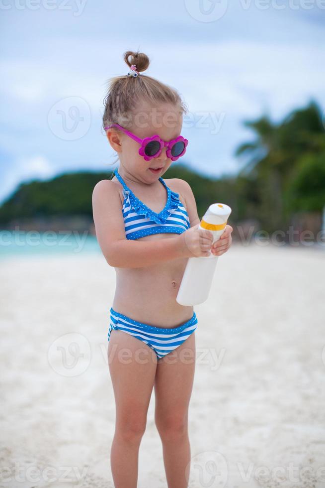 Beautiful little girl on the beach photo