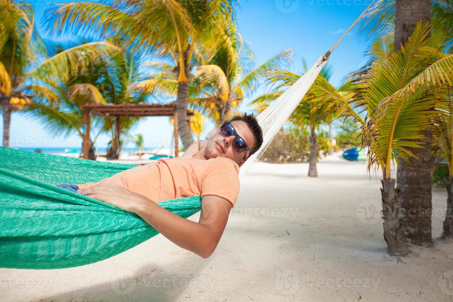Man on a hammock by the beach photo
