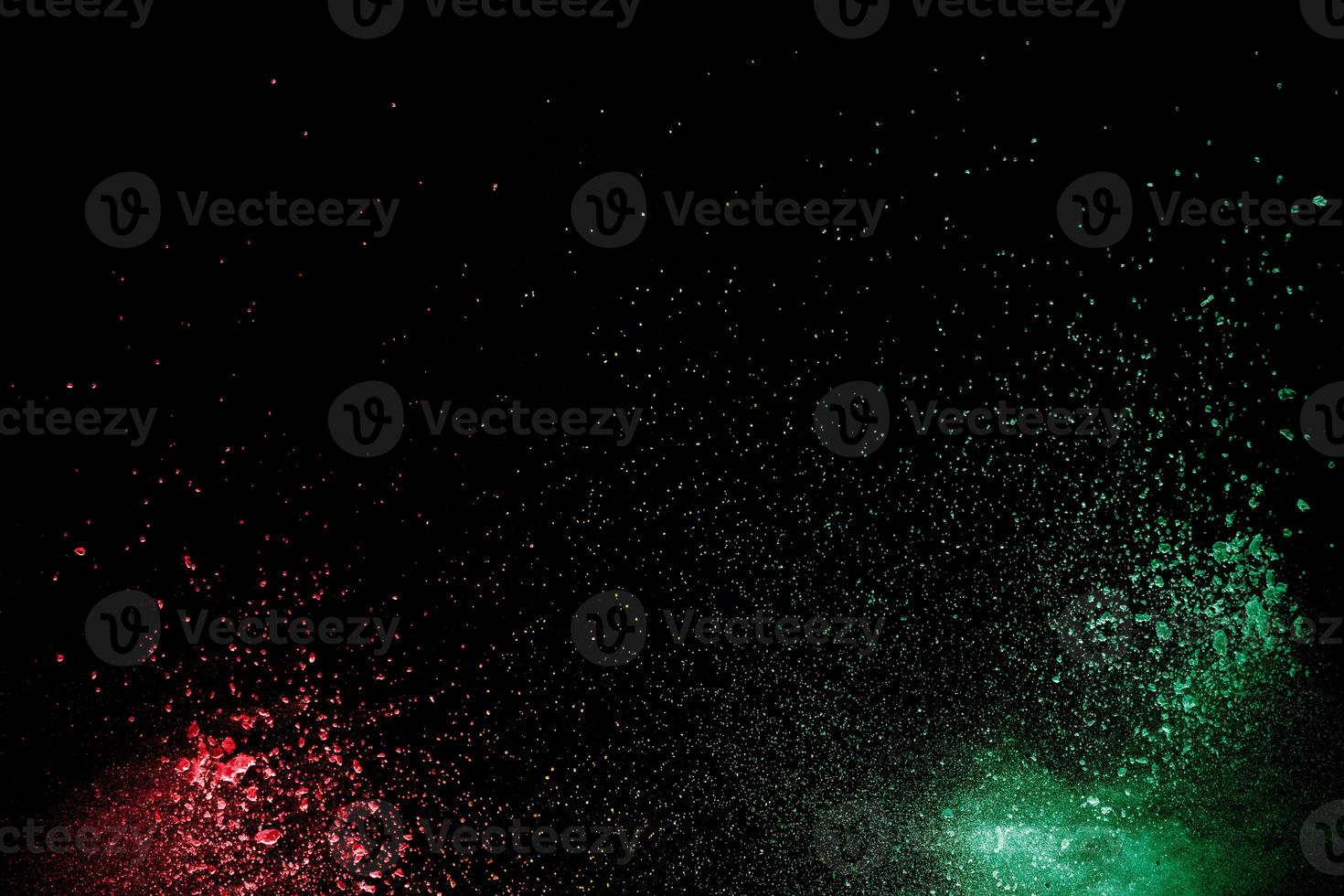 Colorful background of chalk powder. Multicolored dust particles splattered on black background. photo