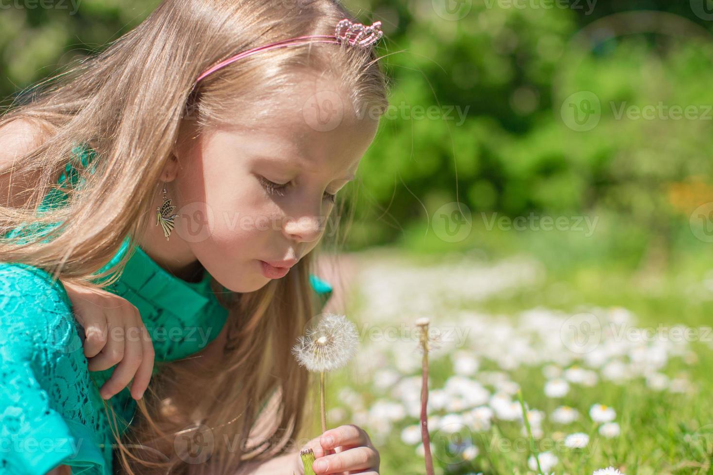 Little girl with flowers in the garden photo