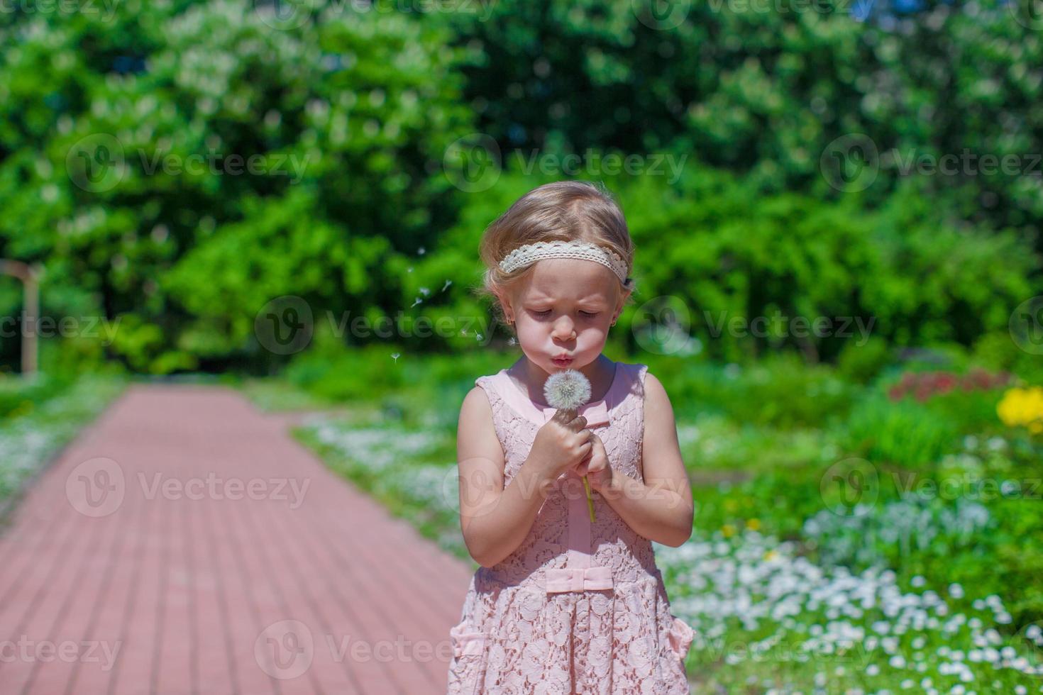 Little girl with flowers in the garden photo