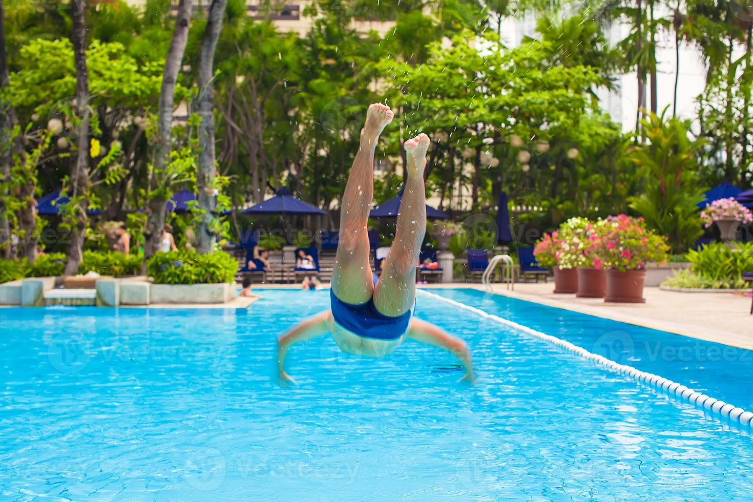 Man jumping on the pool photo