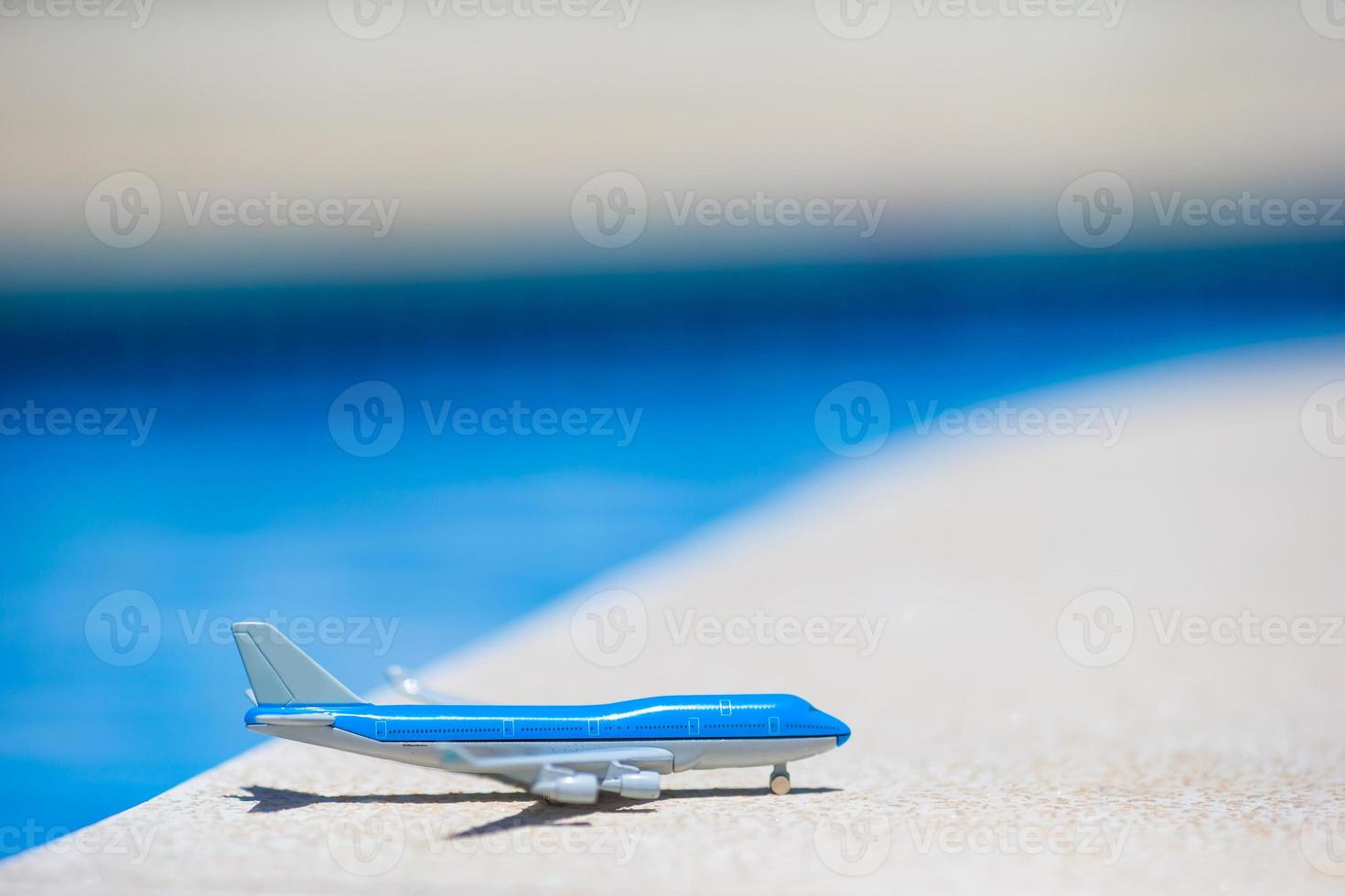 Miniature plane by the pool photo