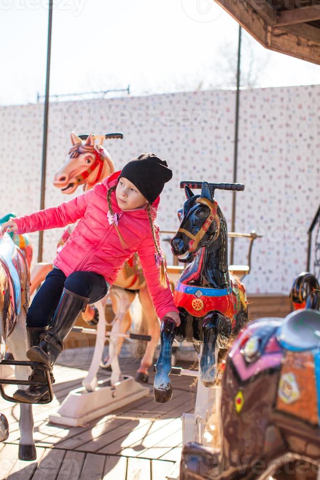 Little girl on a carousel photo