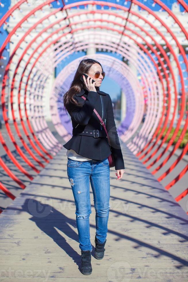 Woman on the phone under a tunnel photo