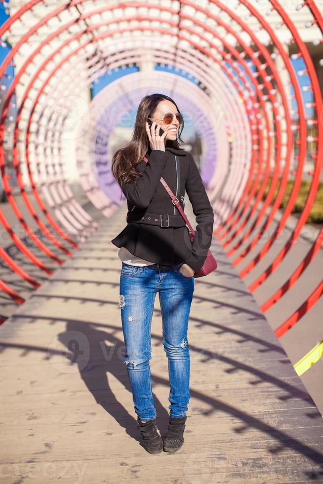 Woman on the phone under a tunnel photo