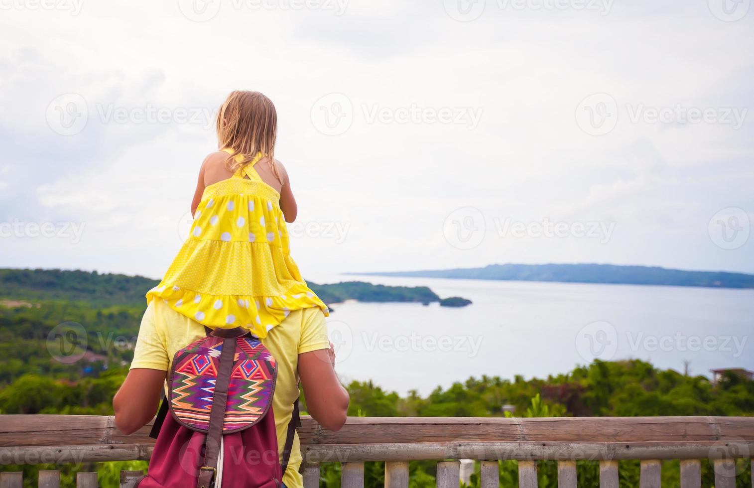 Daughter on her dad's shoulders photo