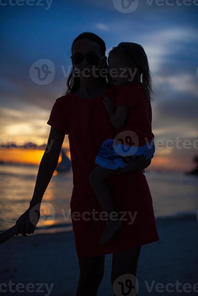 Mother and daughter on the beach photo