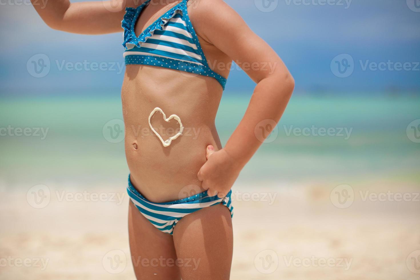 Little girl having fun on the beach photo