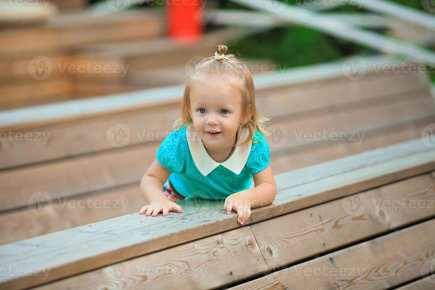 Little baby girl on the bench photo