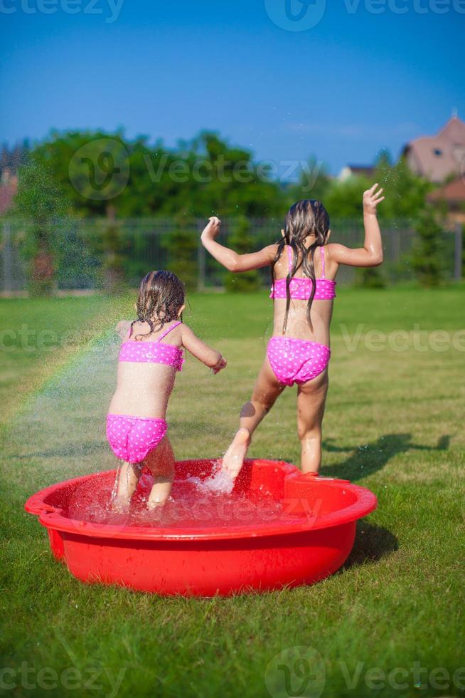 Little sisters having fun in the summer photo