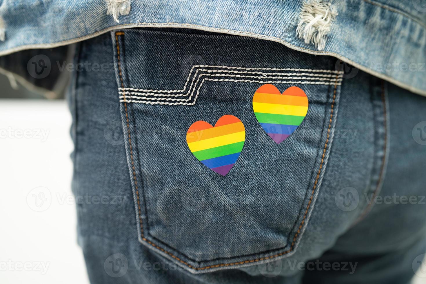 Asian lady with rainbow flag heart, symbol of LGBT pride month celebrate annual in June social of gay, lesbian, bisexual, transgender, human rights. photo