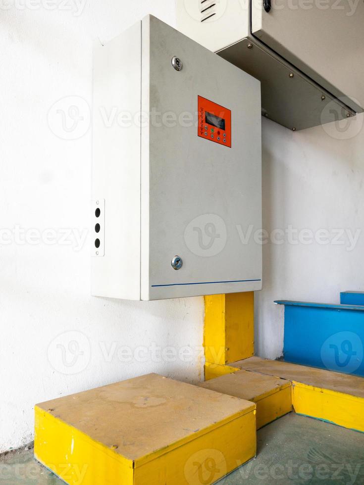 The automatic control box near the white wall. photo