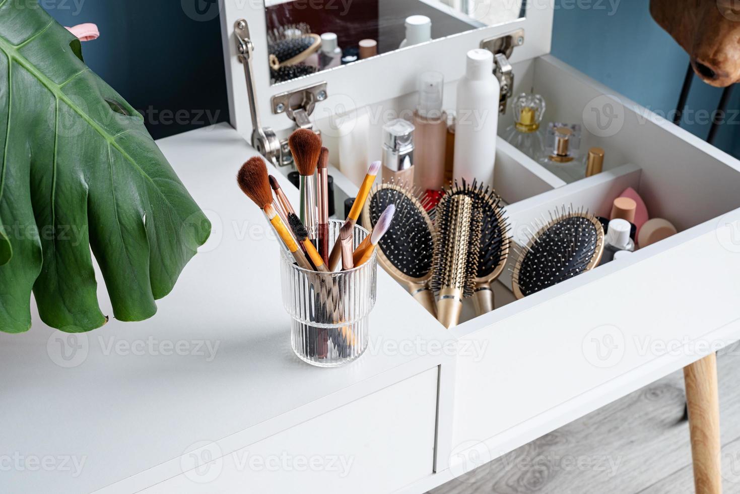 Stylish room interior with elegant dressing table and plants photo