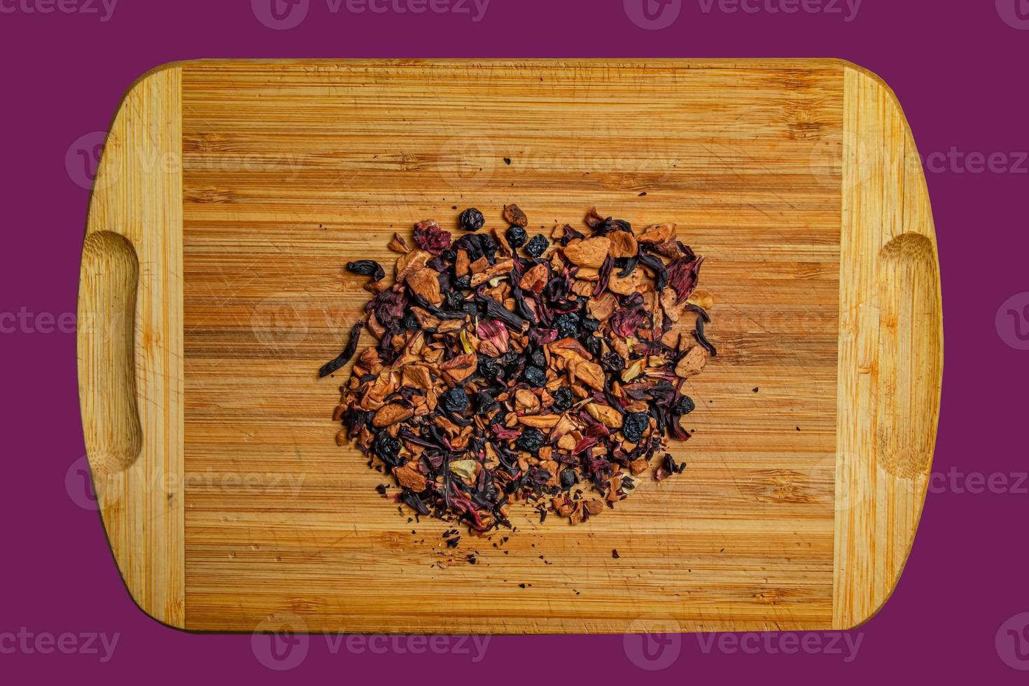 Background of natural fruit tea with hibiscus petals, fruit slices and berries. Fruit tea texture. Top view, flat lay. photo